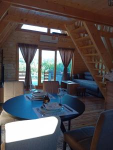 a dining room with a table with wine glasses on it at Brvnara kao na dlanu 2 in Rudnik