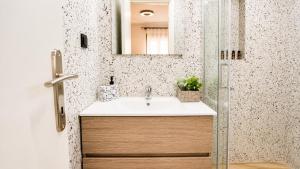 a bathroom with a sink and a mirror at Elaia & Nyx Residence in Volos +10 photos