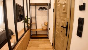 a hallway with a door and a shelf with shoes at Elaia & Nyx Residence in Volos