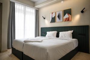 a bedroom with a large bed with a large window at Le Venzia in Sultan Bathery +9 photos