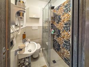 a bathroom with a toilet and a sink and a shower at Il Panoramico - Terrazza e Jacuzzi in Neviano +64 photos