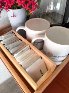a tray full of cups and plates and a vase at L'Astrolabe - Private Beach in Baras