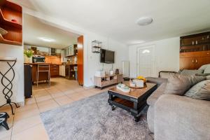 a living room with a couch and a table at Family Retreat near Zagreb with Pool & Garden - Happy Rentals in Velika Buna