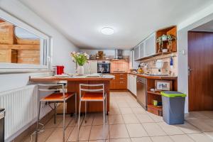 a kitchen with a table and some chairs in it at Family Retreat near Zagreb with Pool & Garden - Happy Rentals in Velika Buna