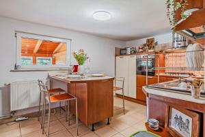 a kitchen with a counter and a table with chairs at Family Retreat near Zagreb with Pool & Garden - Happy Rentals in Velika Buna +35 photos
