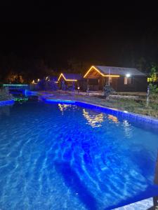a swimming pool at night with a house in the background at Ruby Bungalow Alanya in Yaylalı