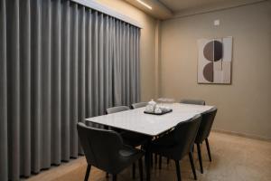 a dining room with a table and chairs at Le Venzia in Sultan Bathery