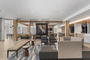 a living room with furniture and a dining room at Hyatt House Thunder Bay in Thunder Bay