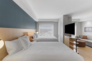 a bedroom with two beds and a flat screen tv at Hyatt House Thunder Bay in Thunder Bay +101 photos