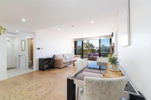 a living room with a couch and a table at Rouse Hills TownCentre luxury accommodation in Kellyville
