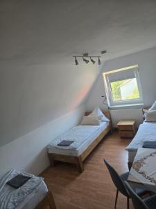 a room with two beds and a window at Karolingerweg Gäst Haus in Lauterhofen +54 photos