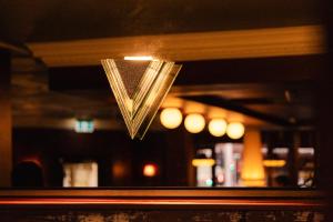 a glass window with a sign that says v at The Strand Hotel in Sydney