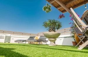 a garden with benches and a fountain in the grass at Il Panoramico - Terrazza e Jacuzzi in Neviano