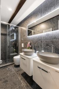 a bathroom with two sinks and a shower at Split Old Town Rooms Matushko in Split