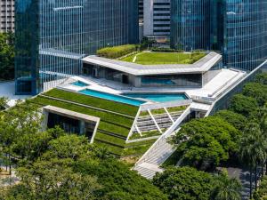 a building with a garden on the side of it at Mandarin Oriental Makati, Manila in Manila