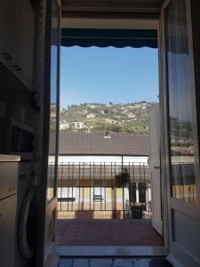an open door to a balcony with a view of a building at Il Cuore di Santa è tutto blu in Santa Margherita Ligure