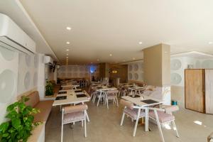 a restaurant with tables and chairs in a room at Aqua Fun Resort in Hurghada