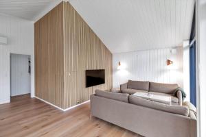 a living room with a couch and a tv at 13397-Vig-Lyngkrogen-21 in Vig