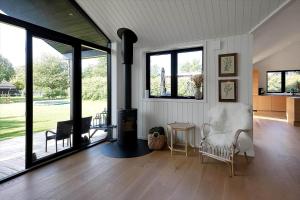 a living room with a fireplace and a table with chairs at 13397-Vig-Lyngkrogen-21 in Vig