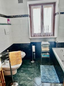 a bathroom with a toilet and a sink and a window at La villetta di Lilly in Predaia +25 photos