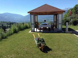a gazebo with a table and a table at La villetta di Lilly in Predaia