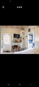 a picture of a living room with a bed at Cosy Hut in Saint Georgeʼs