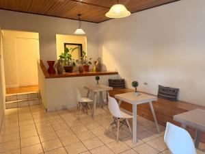 a dining room with two tables and white chairs at Inari Guatemala in Guatemala