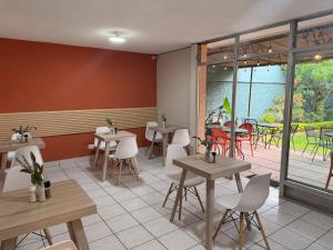 a restaurant with tables and chairs and a patio at Inari Guatemala in Guatemala +14 photos
