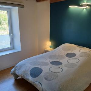 a bedroom with a bed in a room with a window at Le Nolan in Cublize +48 photos