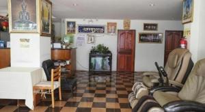 a living room with a couch and a fireplace at Phetsuwan Hotel in Phetchabun