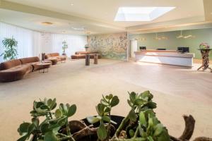 a large living room with couches and a piano at Best Western Hotel Mainz in Mainz