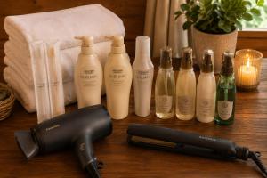 a hair dryer next to a group of bottles on a table at ペンションハートウォーマー in Myoko