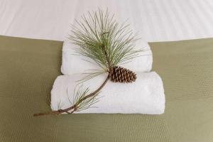 a towel with a pine tree on top of it at Novena Pines by Tiny Away in Thulimbah