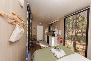 a room with a bed and a large window at Novena Pines by Tiny Away in Thulimbah +20 photos
