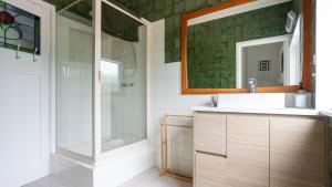 a bathroom with a sink and a shower and a mirror at Three Oaks in Red Hill +19 photos