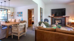 a living room with a couch and a fireplace at Three Oaks in Red Hill