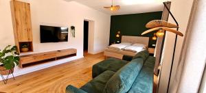 a living room with a couch and a bed at Ferienwohnungen Meier in Ebensee
