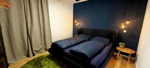 a bed with blue pillows in a room at Ferienwohnungen Meier in Ebensee