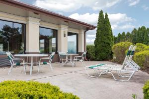 a patio with a table and chairs in front of a house at Quality Inn Sycamore - DeKalb in Sycamore