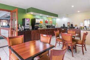 a restaurant with a table and chairs and a kitchen at Quality Inn Sycamore - DeKalb in Sycamore