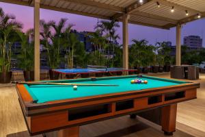 a pool table in a room with a pool at Grand Hotel Guayaquil, Centro Histórico in Guayaquil