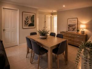 a dining room with a wooden table and chairs at Coastal Haven Retreat 3BR Escape in Kinross in Kinross