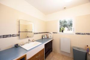 a bathroom with a sink and a mirror at Villa Helychrisa in Aléria +30 photos