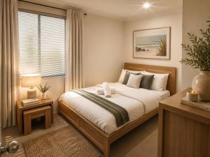 a bedroom with a large bed and a window at Coastal Haven Retreat 3BR Escape in Kinross in Kinross