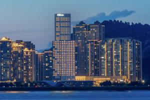 a large city with tall buildings at night at Hilton Wenzhou in Wenzhou