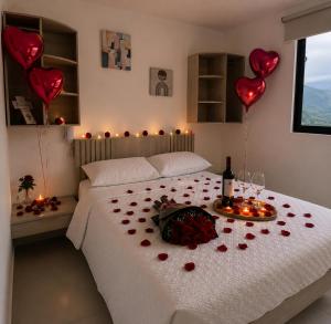 a bedroom with a bed with hearts and balloons at Hotel Zona Oro in Armenia