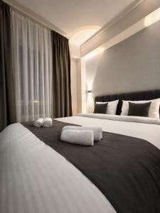 a hotel room with two towels on a bed at Urban Hotel in Bishkek