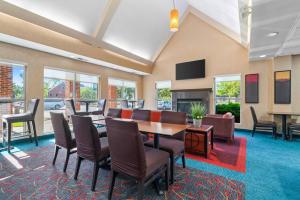a conference room with a table and chairs and a fireplace at MainStay Suites Appleton Airport - Fox River Mall Area in Appleton