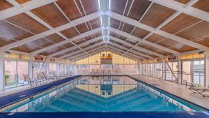 a large swimming pool with a large ceiling at Quality Inn & Suites in Williamsburg