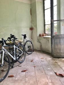 two bikes parked in a room with a window at L'Hotel de Hercé Chambre d'Hote in Mayenne